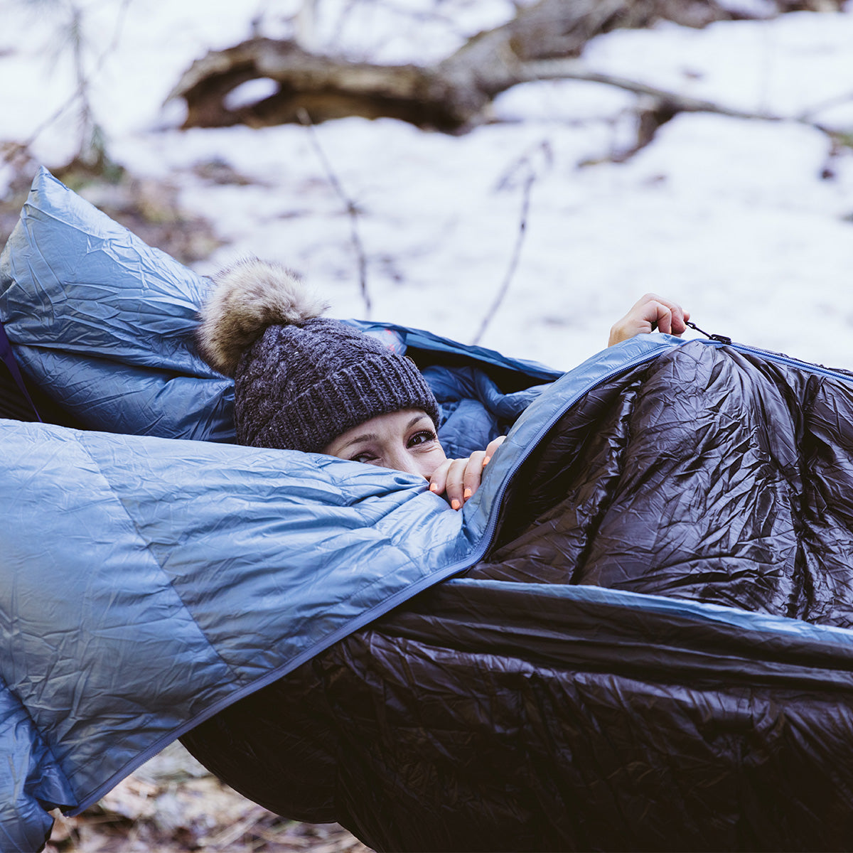 woman smiling in evolution sleeping bag hammock