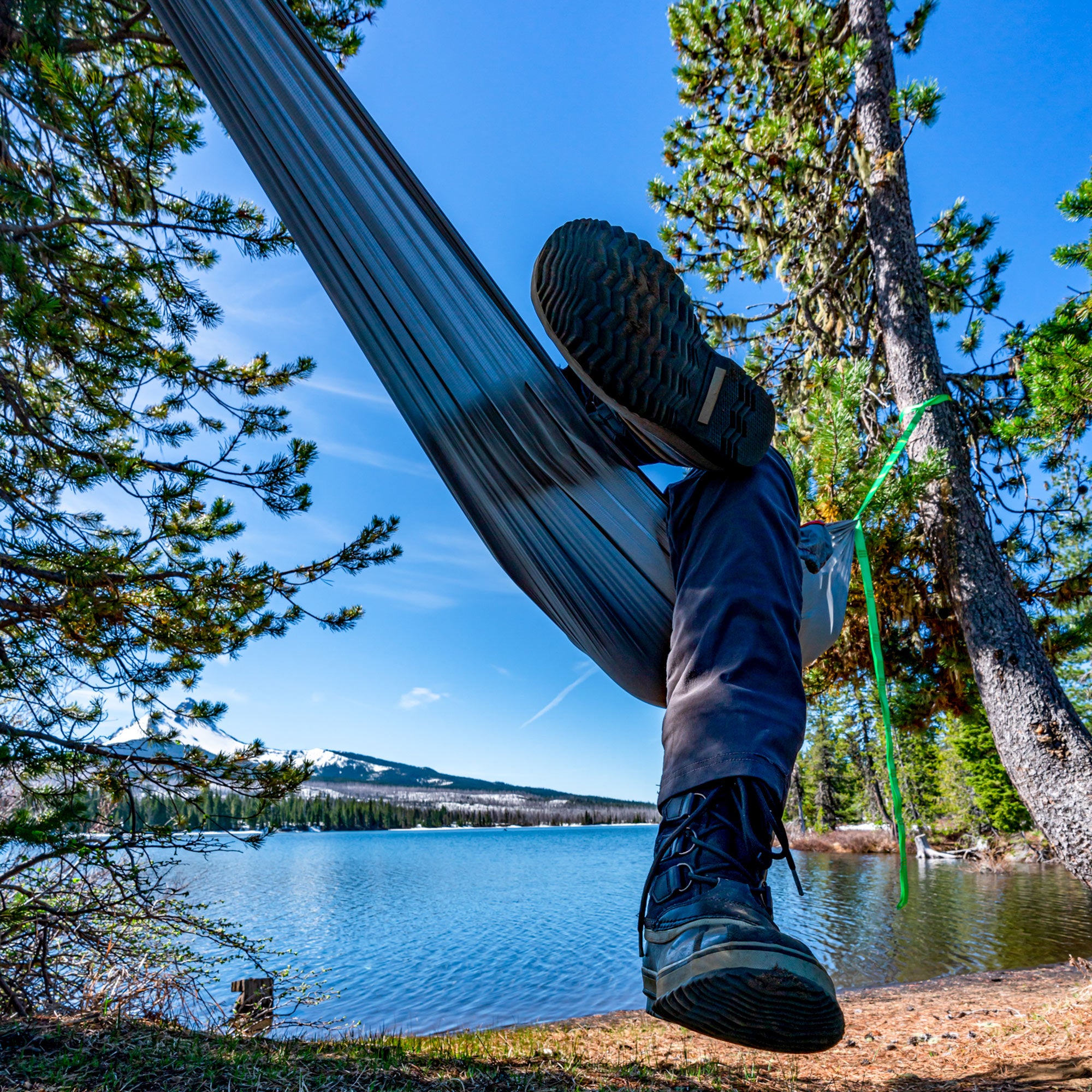 Lounging in the Grand Trunk Nano 7 Hammock next to a lake and potentially mt. hood in the background