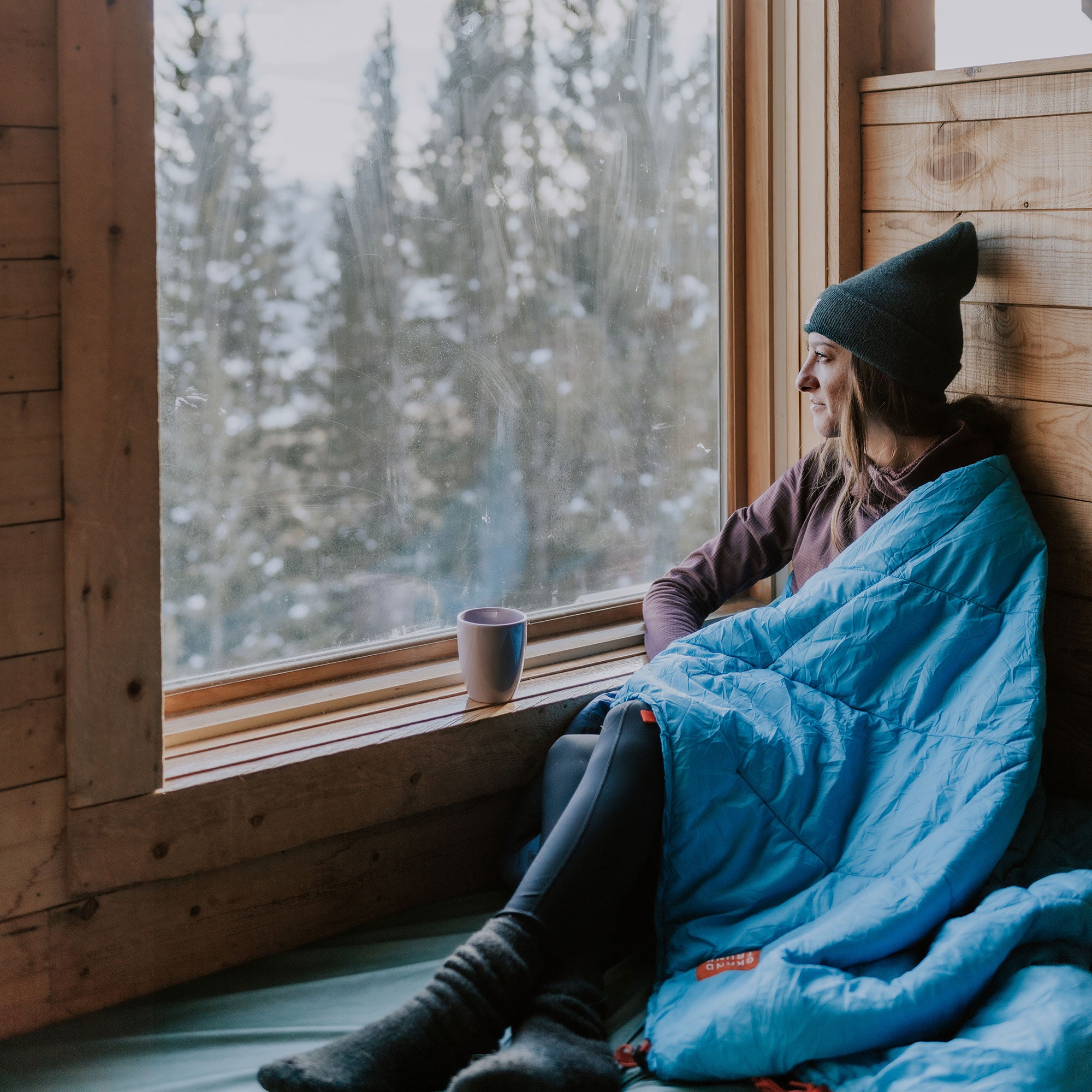 thermaquilt on a cozy winter day woman inside a cabin