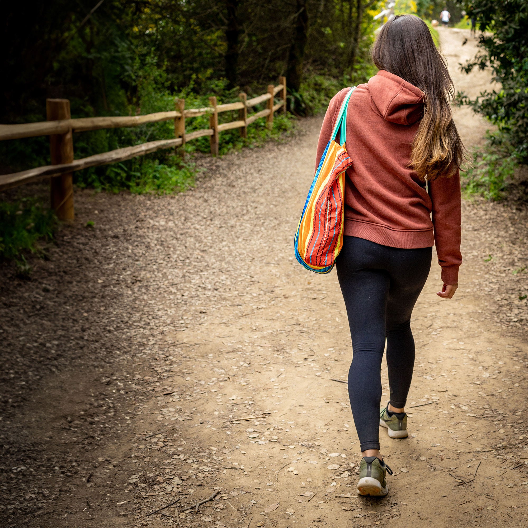 woman hiking trail with eco tote bag outdoor