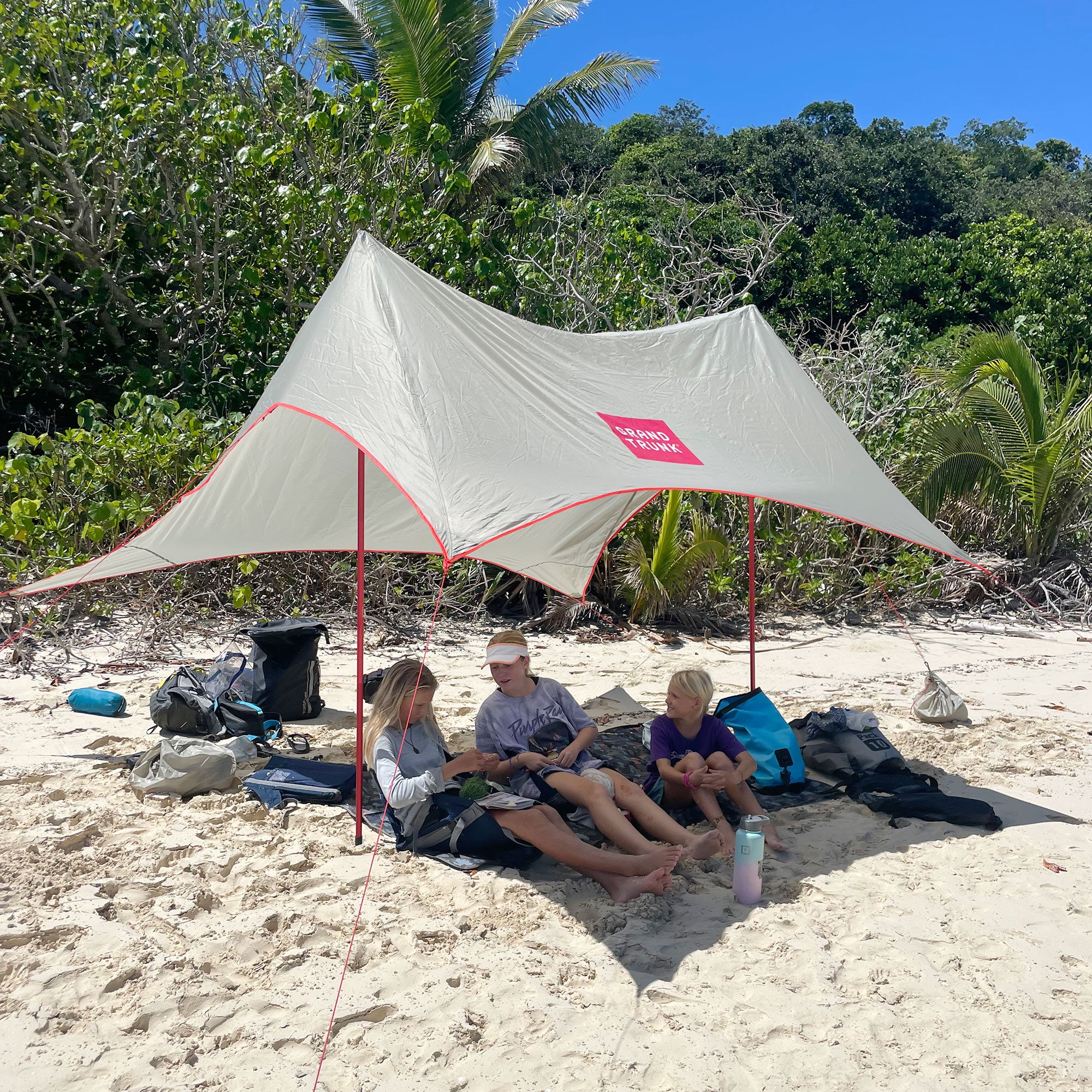 shadecaster 4 on the beach protecting some young women from the sun