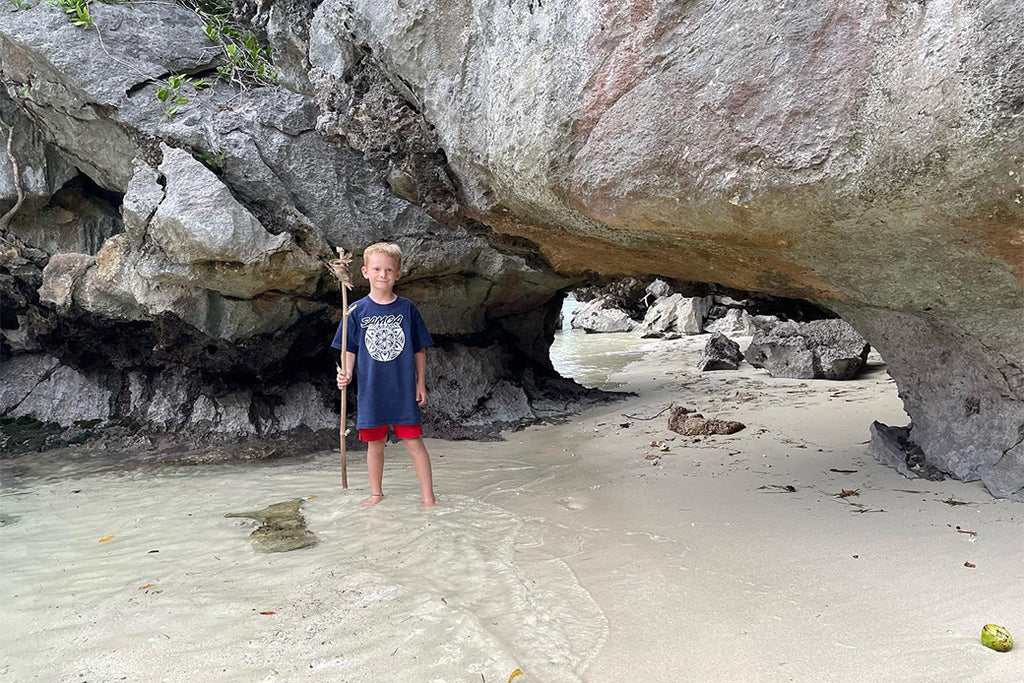 Boy spearfishing near the pacific ocean with a captured crab