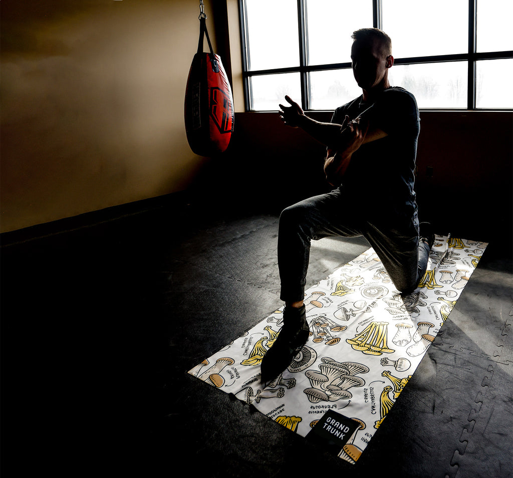 man using microfiber towel for yoga inside gym athletics