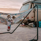 Dog in Grand Trunk Hammock Stand next to camper van in the desert