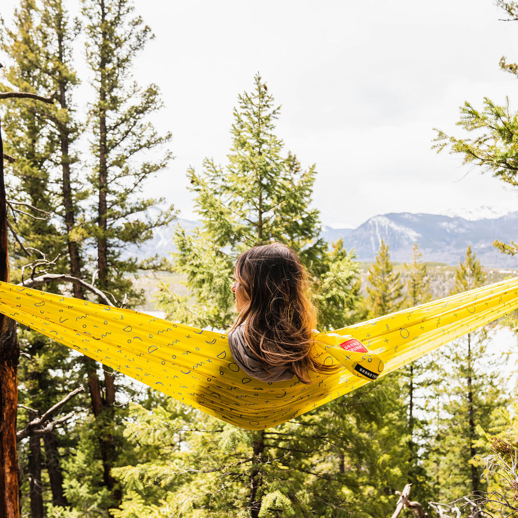 eclipse print TrunkTech™ hammock in the forest by a lake with mountains in the background camping lightweight adventure