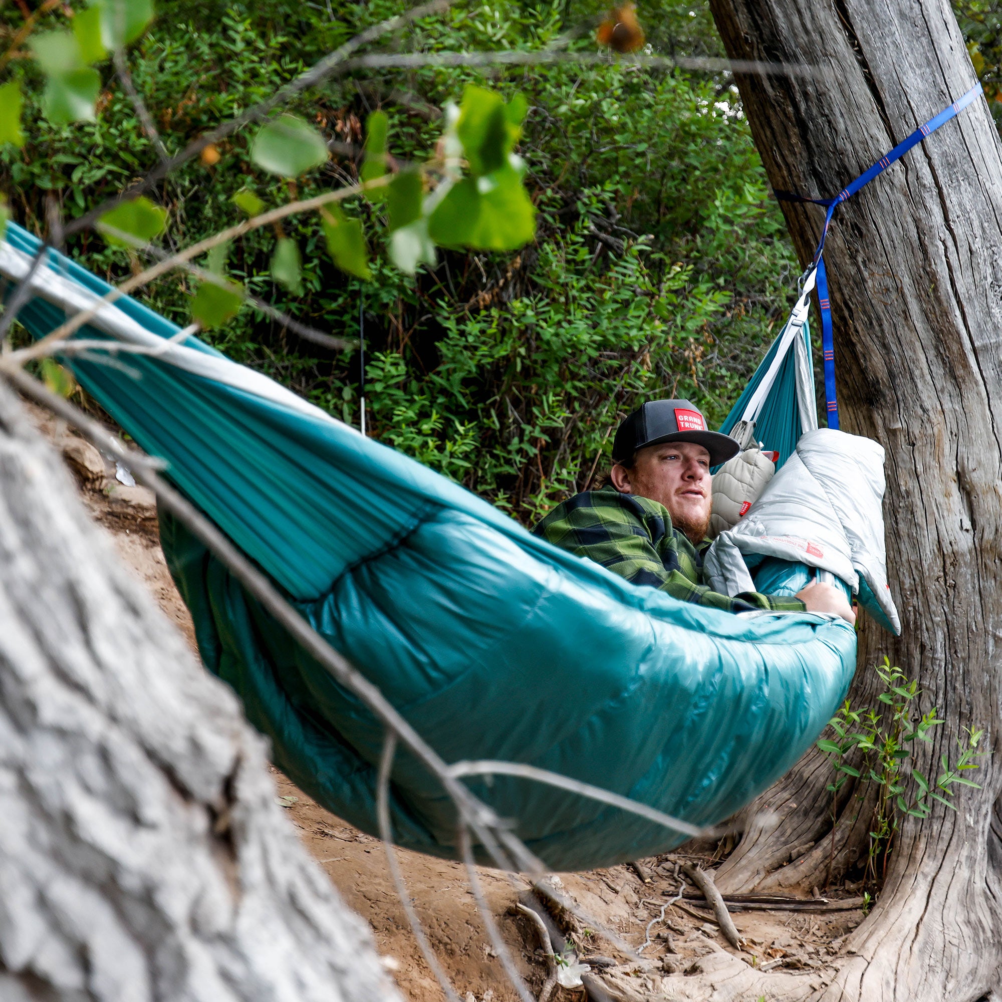 Man laying in Grand Trunk Evolution Hammock looking at nature admiring its beauty