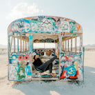 Woman relaxing in Grand Trunk Mayfly Chair inside of a grafitti bus