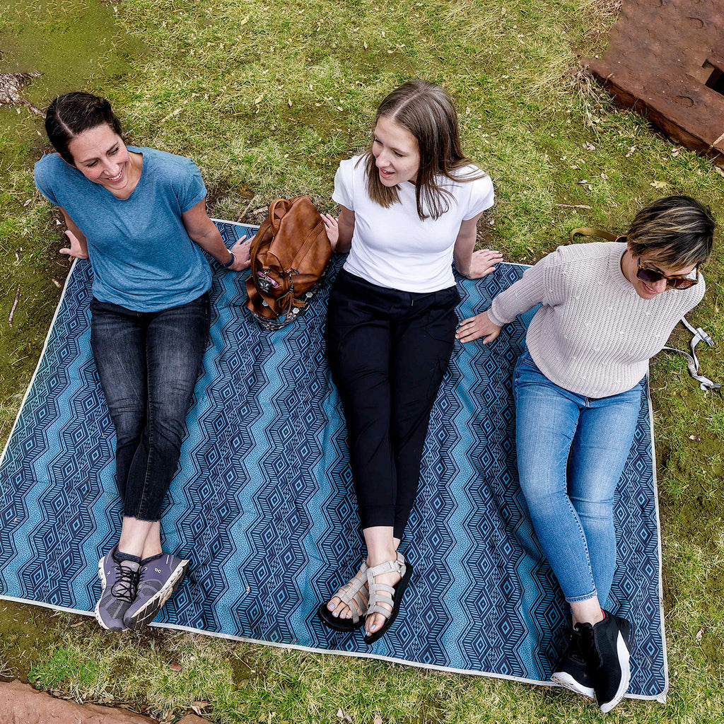 3 ladies relaxing laughing at the park sitting on the Grand Trunk Meadow Mat