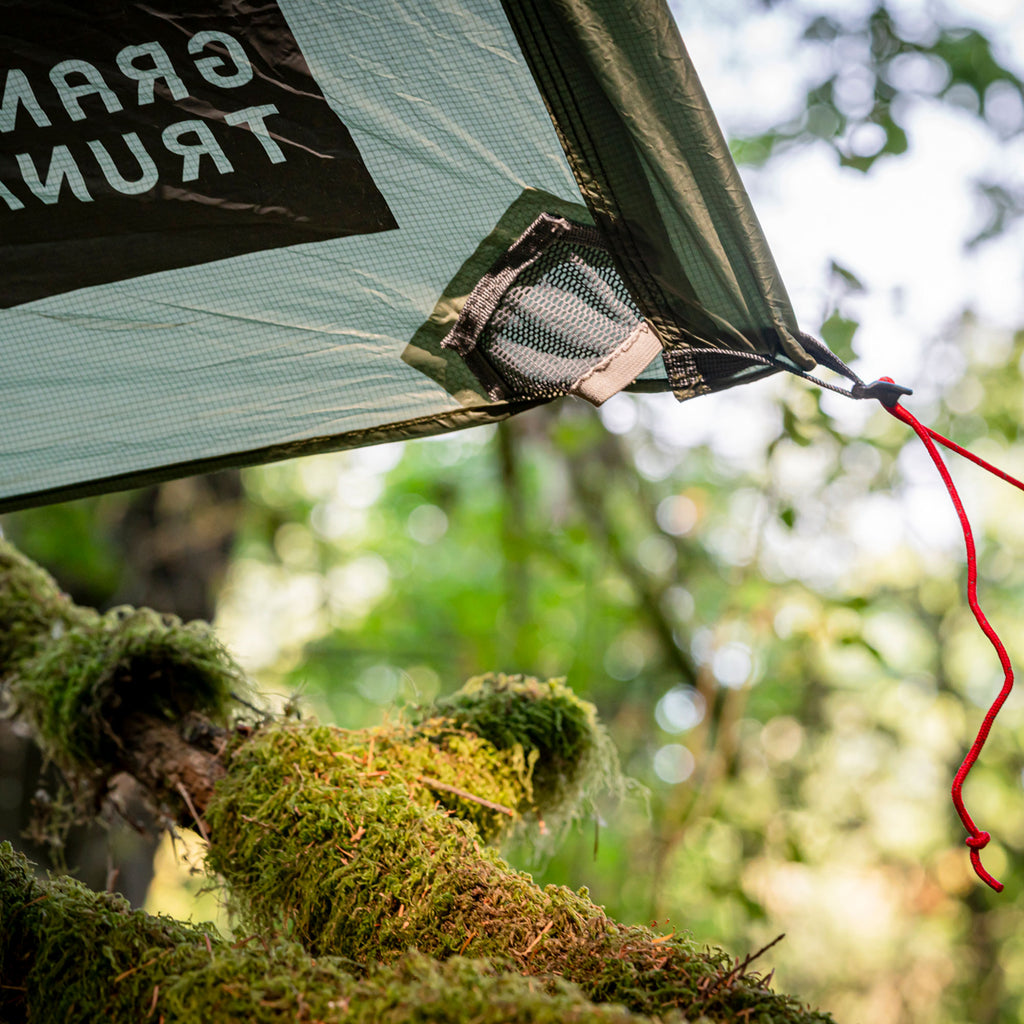 detail shot of the moab cinch cord pockets and corner loop with the logo and mossy branches