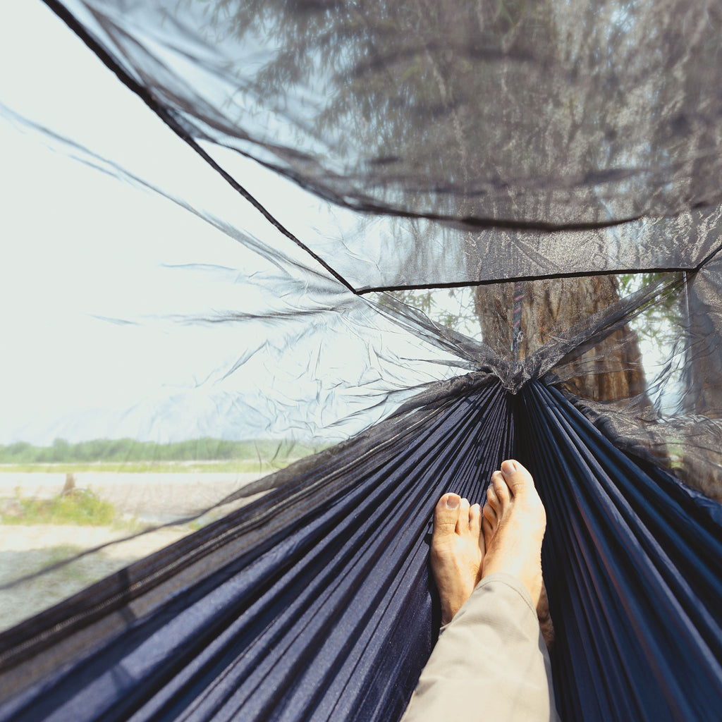 first person viewpoint of laying inside the skeeter beeter hammock. barefoot and relaxed